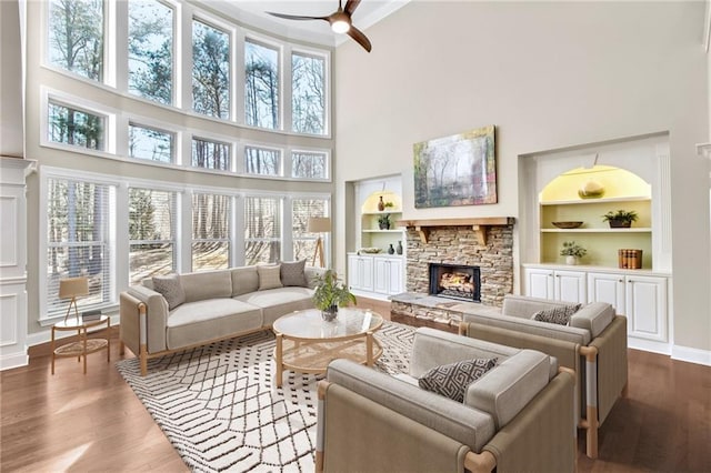 sunroom featuring a fireplace and ceiling fan