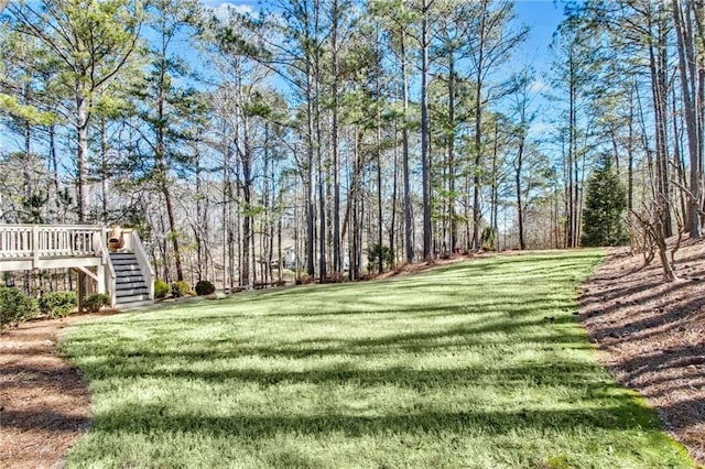 view of yard featuring stairway and a wooden deck