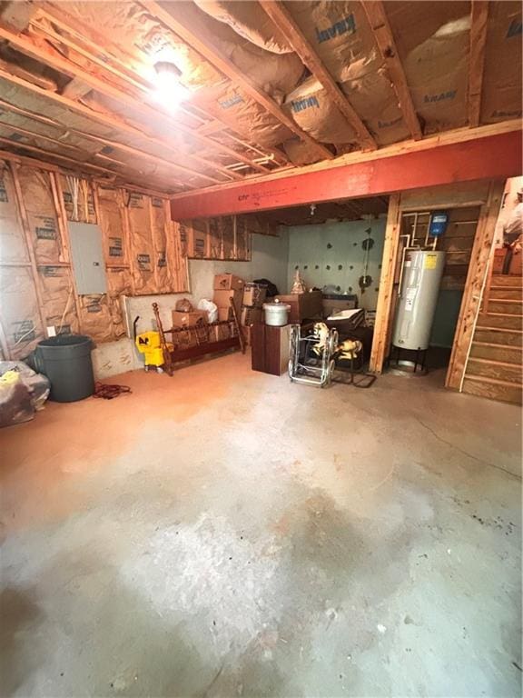 unfinished below grade area featuring water heater, stairs, and electric panel