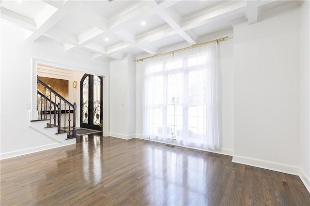 unfurnished living room featuring coffered ceiling, dark wood-type flooring, and beamed ceiling