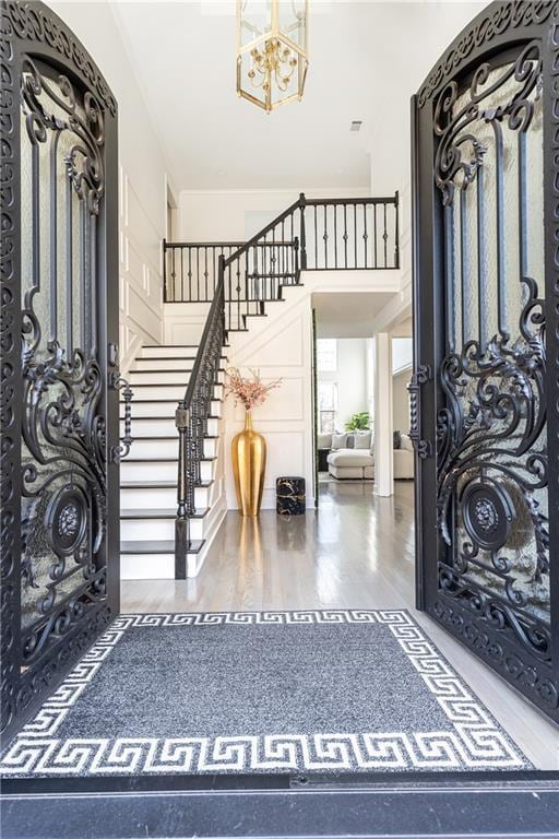 entryway with a chandelier and hardwood / wood-style floors