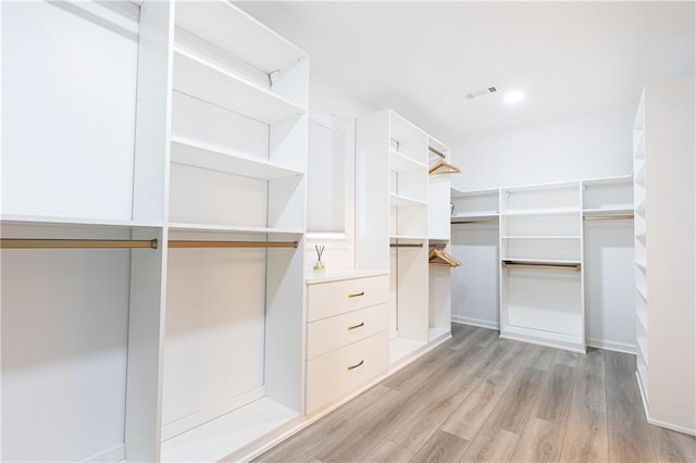 walk in closet featuring light hardwood / wood-style flooring