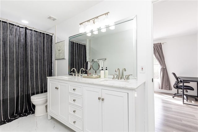 bathroom featuring vanity and toilet