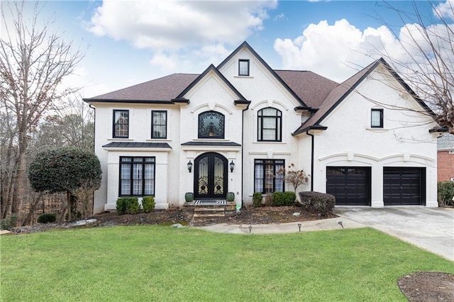 french country inspired facade featuring a garage, a front lawn, and french doors