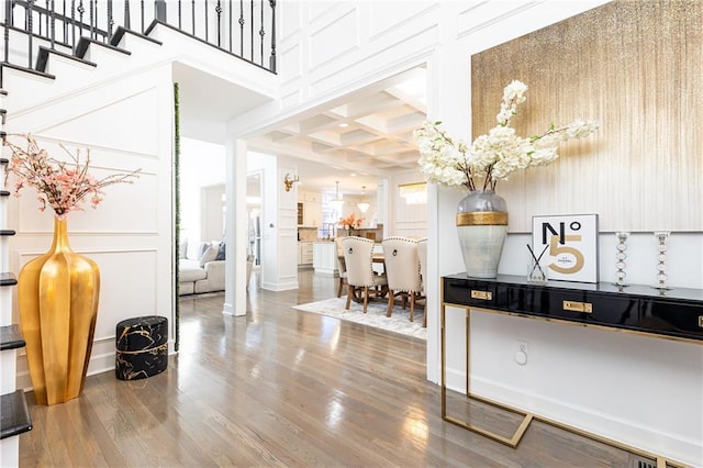 interior space featuring coffered ceiling, wood-type flooring, and beamed ceiling