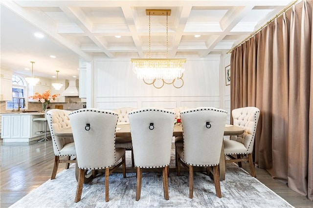 dining room featuring beamed ceiling, coffered ceiling, and an inviting chandelier