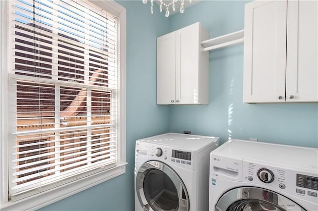 laundry area featuring a healthy amount of sunlight, cabinet space, and independent washer and dryer