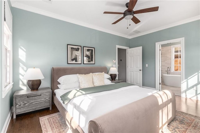 bedroom featuring baseboards, connected bathroom, ornamental molding, and wood finished floors