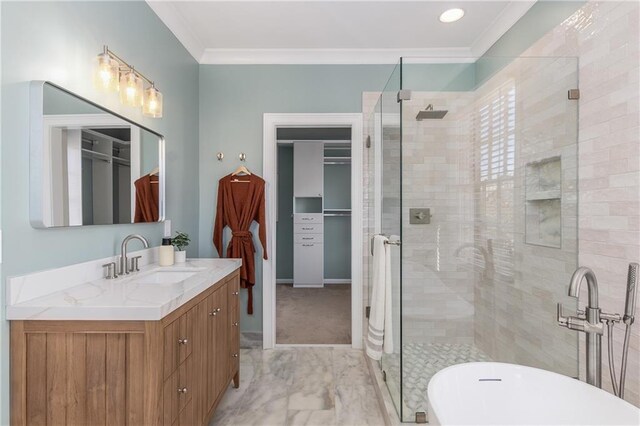 full bathroom with marble finish floor, crown molding, a shower stall, vanity, and a freestanding tub