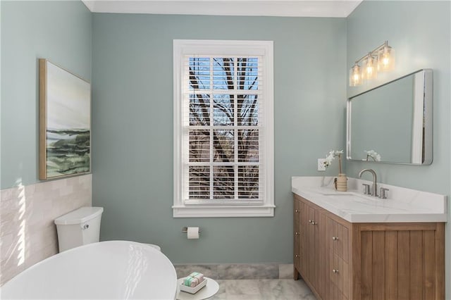 full bathroom with a soaking tub and vanity