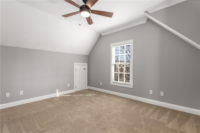 bonus room featuring lofted ceiling, carpet flooring, and baseboards