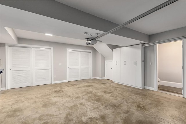 additional living space with concrete floors and baseboards