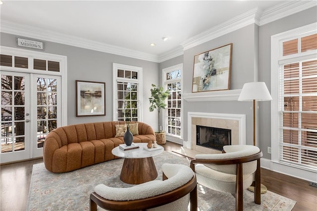 living area featuring a premium fireplace, wood finished floors, crown molding, french doors, and recessed lighting