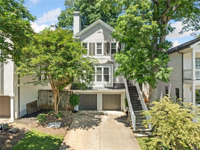 3232 Cates Ave NE, Brookhaven, GA 30319 - view of front facade with stairs, an attached garage, concrete driveway, and a chimney