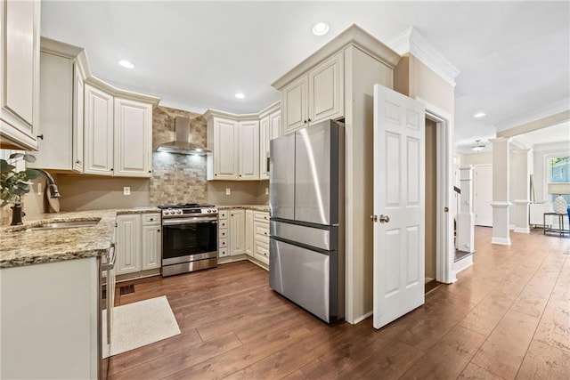 3232 Cates Ave NE, Brookhaven, GA 30319 - kitchen featuring appliances with stainless steel finishes, wall chimney exhaust hood, a sink, ornamental molding, and dark wood finished floors