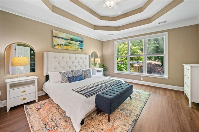 3232 Cates Ave NE, Brookhaven, GA 30319 - bedroom featuring baseboards, a tray ceiling, ornamental molding, and wood finished floors
