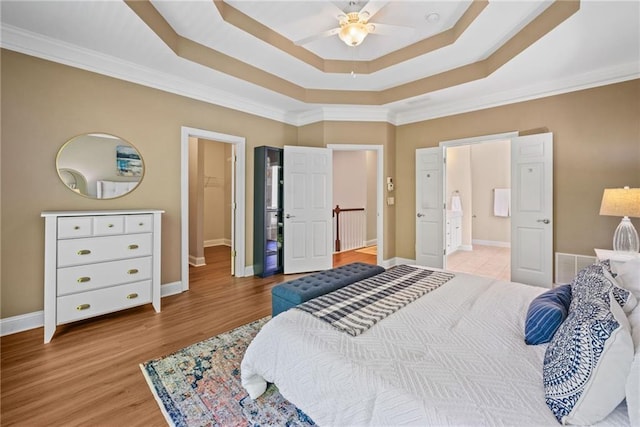 3232 Cates Ave NE, Brookhaven, GA 30319 - bedroom with a raised ceiling, baseboards, ornamental molding, light wood finished floors, and connected bathroom