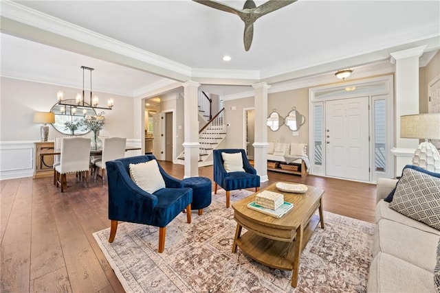 3232 Cates Ave NE, Brookhaven, GA 30319 - living room with decorative columns, hardwood / wood-style floors, crown molding, stairs, and a ceiling fan