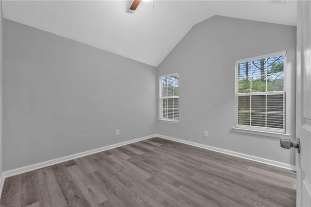 spare room with lofted ceiling, hardwood / wood-style flooring, and ceiling fan