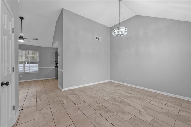 spare room featuring vaulted ceiling and ceiling fan with notable chandelier