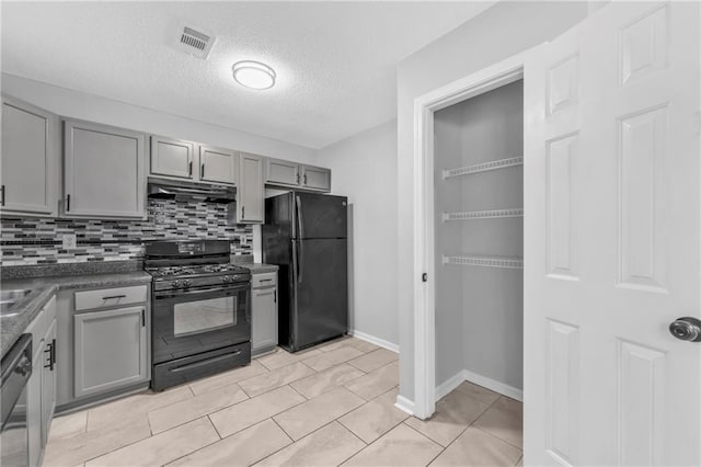 kitchen featuring gray cabinetry, backsplash, black appliances, and a textured ceiling