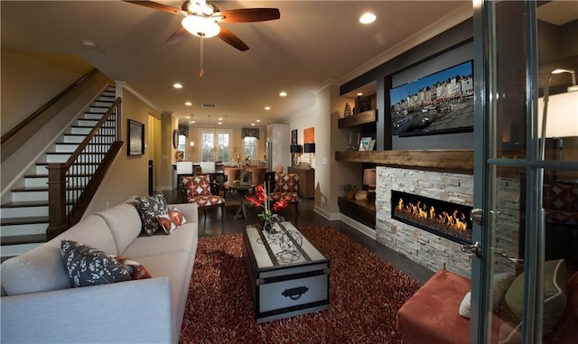 living room featuring ornamental molding, dark hardwood / wood-style flooring, ceiling fan, and a fireplace