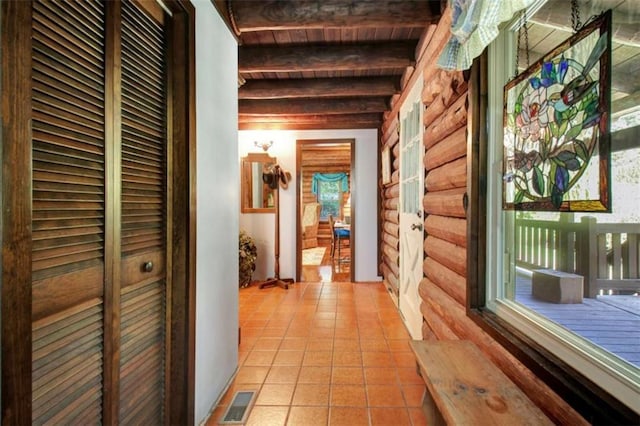 corridor featuring wooden ceiling, log walls, and beamed ceiling