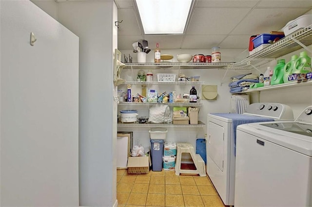 clothes washing area with separate washer and dryer and light tile patterned floors