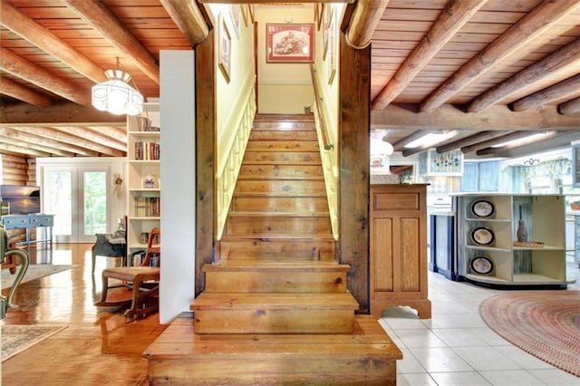 stairway featuring wood ceiling, log walls, and beamed ceiling