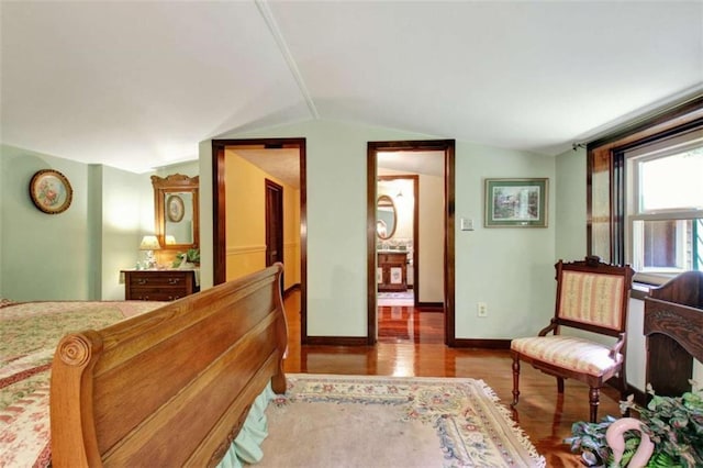 bedroom featuring light hardwood / wood-style floors and lofted ceiling