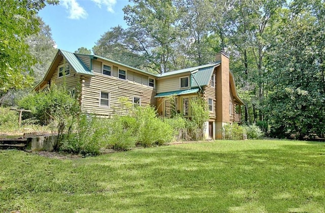 rear view of property featuring a yard