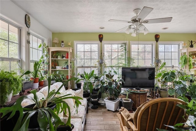 sunroom featuring plenty of natural light and ceiling fan