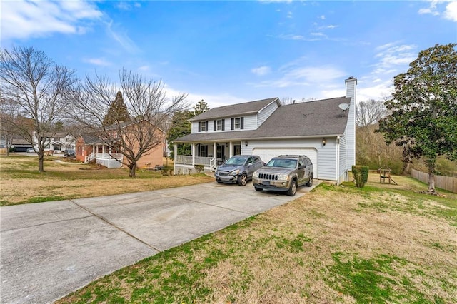 view of front of property with a garage, driveway, a chimney, and a front lawn