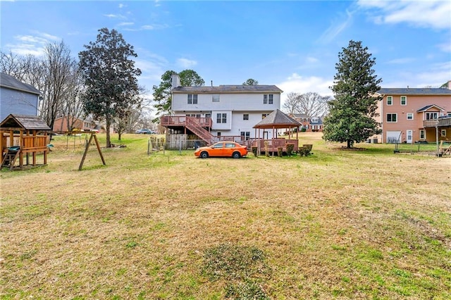 rear view of property with a gazebo and a lawn
