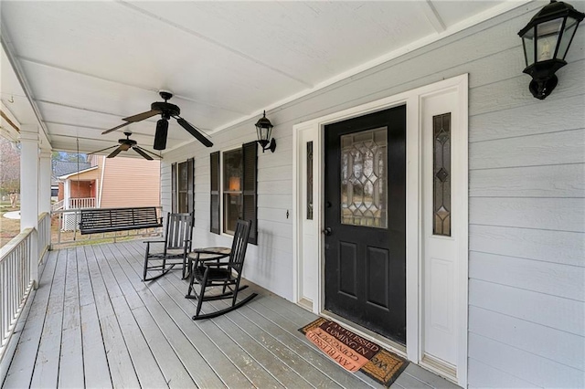 wooden deck with covered porch and ceiling fan