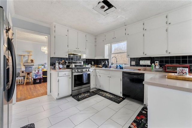kitchen with under cabinet range hood, a sink, appliances with stainless steel finishes, ornamental molding, and backsplash