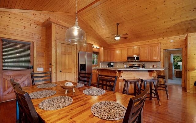 dining space featuring wood-type flooring, wood ceiling, and wood walls