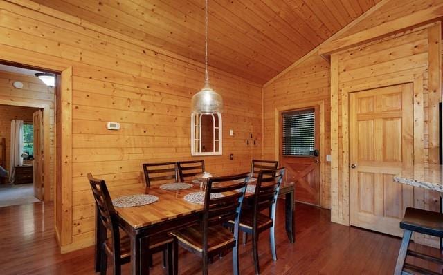 dining space featuring wooden ceiling, lofted ceiling, wooden walls, and dark hardwood / wood-style flooring