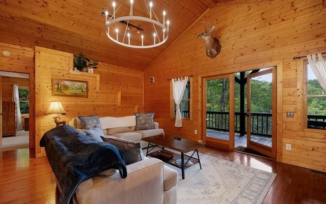 living room with wooden walls and hardwood / wood-style flooring