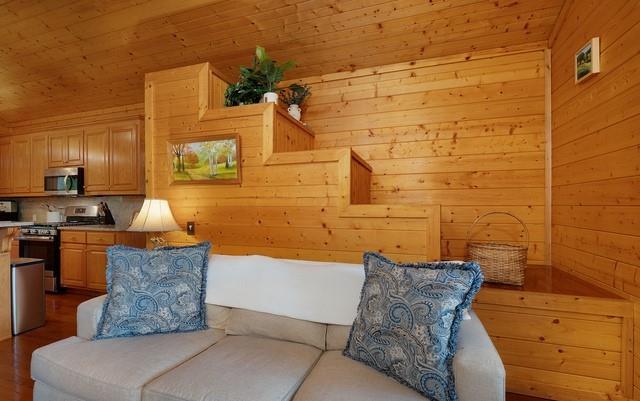 living area featuring wood ceiling, wooden walls, and light hardwood / wood-style floors