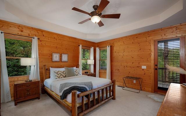 bedroom featuring light colored carpet, multiple windows, access to outside, and ceiling fan