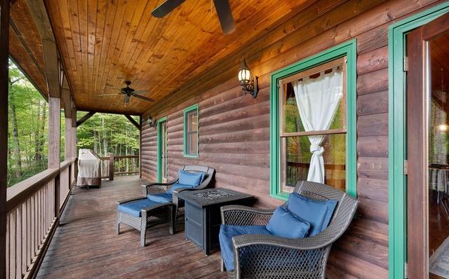 deck with ceiling fan and a porch