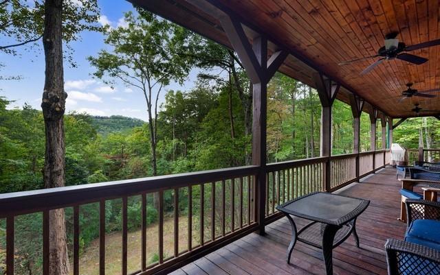 wooden terrace featuring ceiling fan