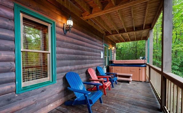 wooden terrace featuring a hot tub