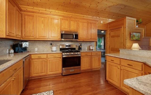 kitchen featuring wood ceiling, light wood-type flooring, decorative backsplash, and appliances with stainless steel finishes