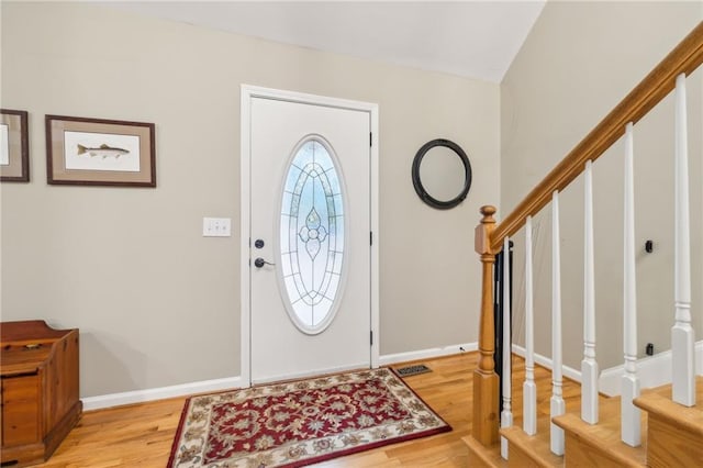 entrance foyer featuring lofted ceiling and light hardwood / wood-style flooring