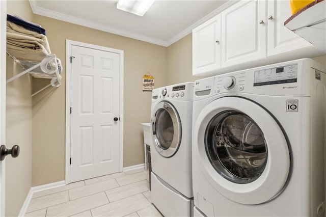 clothes washing area featuring cabinets, ornamental molding, and independent washer and dryer