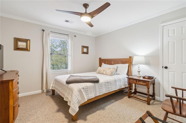 carpeted bedroom with ceiling fan and ornamental molding