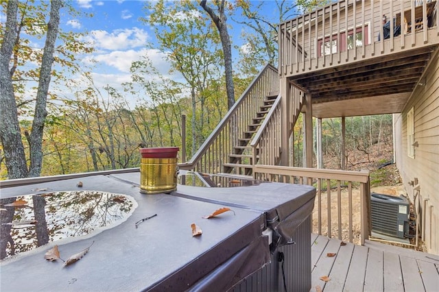 deck featuring a hot tub and central AC