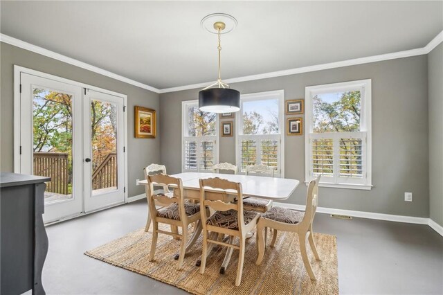 dining area with crown molding and concrete floors